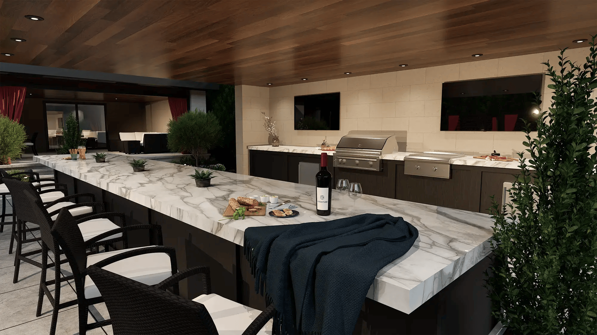 Luxury outdoor kitchen with marble island, built-in grill, bar seating, and integrated cabinetry