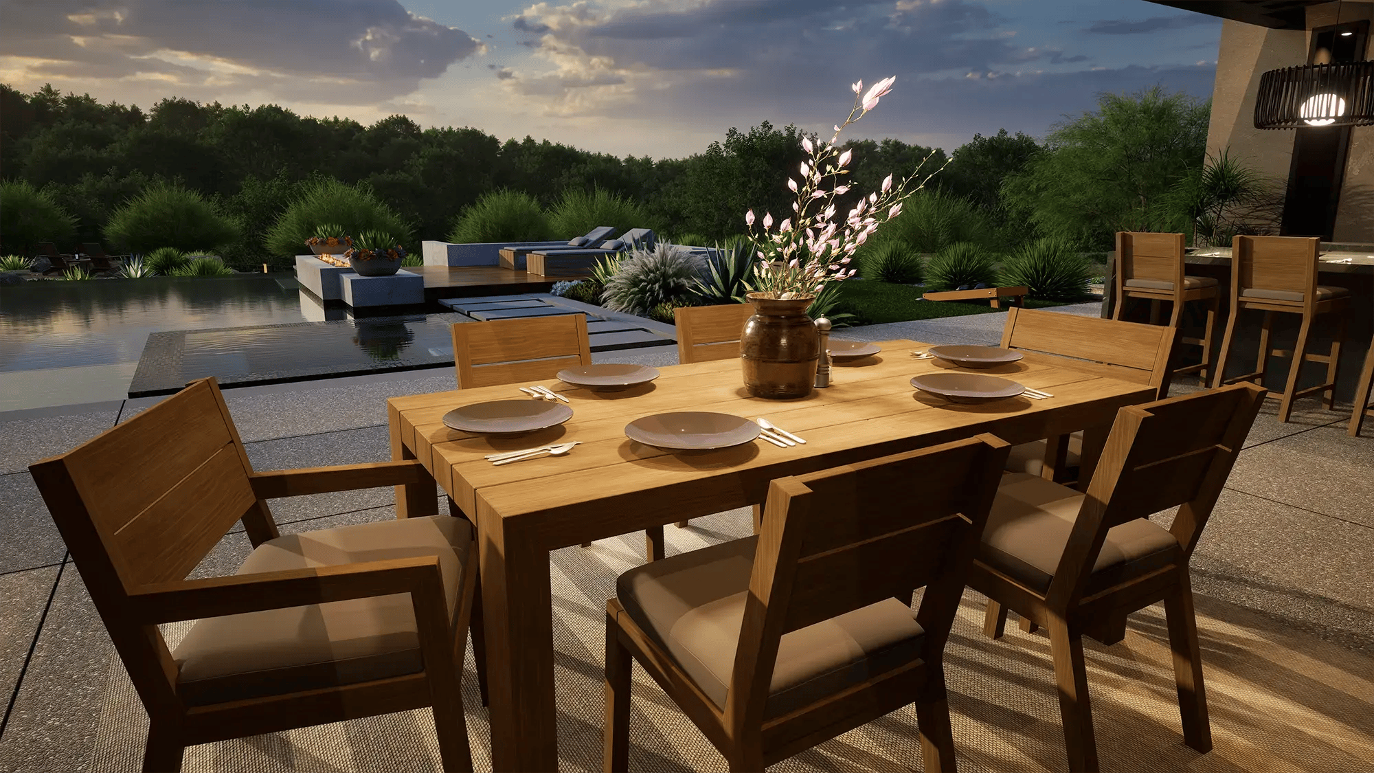 Infinity-edge pool at sunset with fire feature, lounge seating, and natural landscape views
